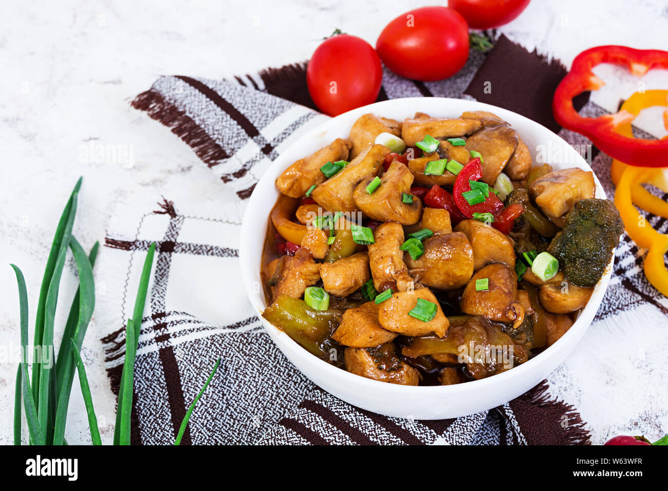 Stir Fry Chicken with peppers and mushrooms on white background Stock