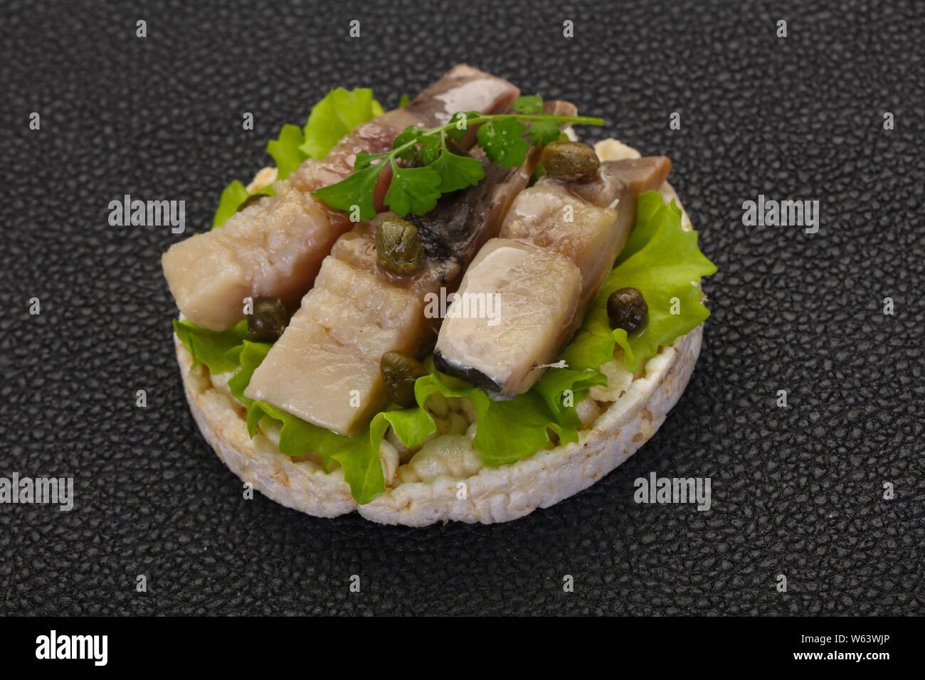 Snack with herring served capers Stock Photo Alamy