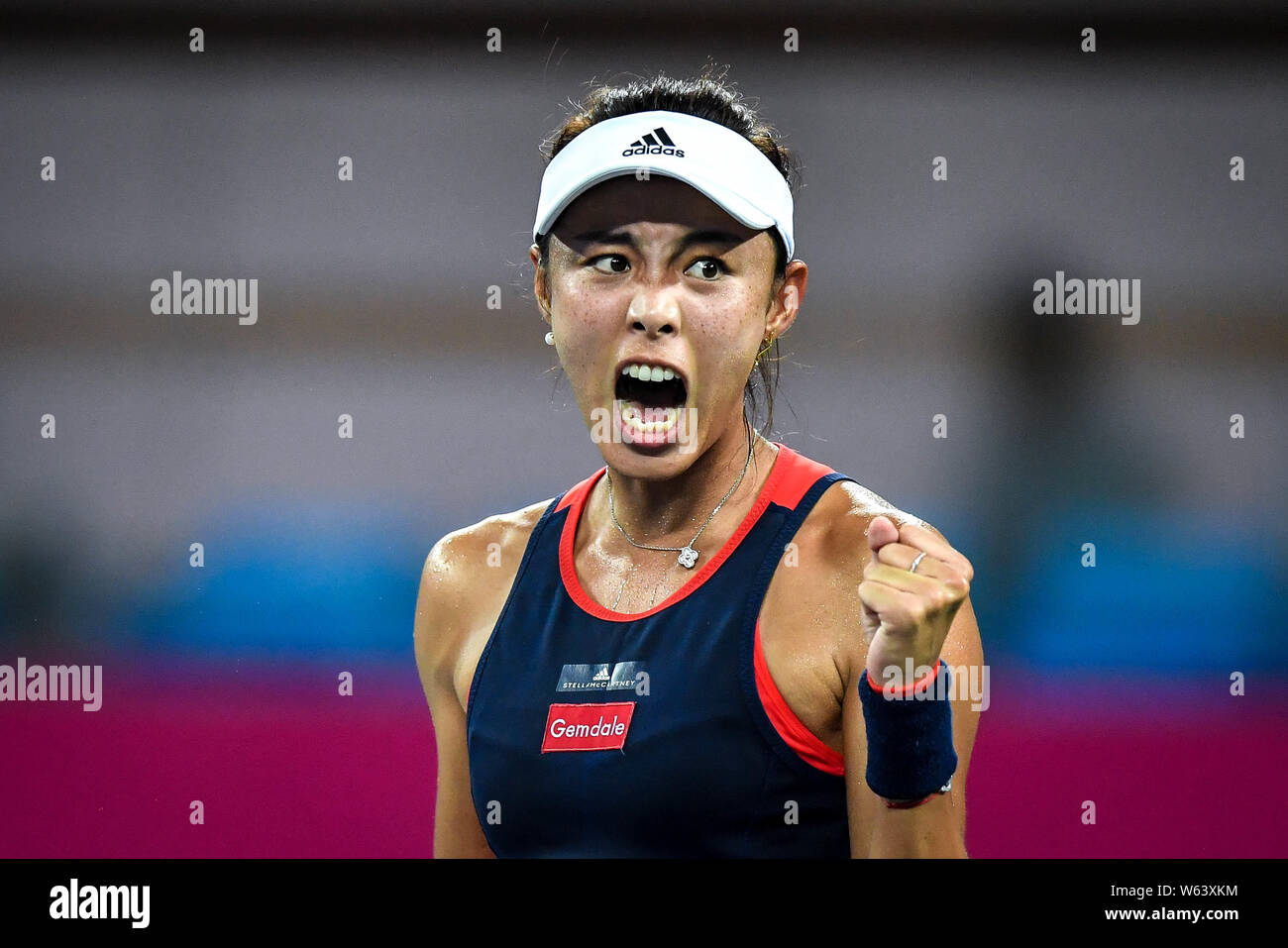 Wang Qiang of China reacts after scoring against Fiona Ferro of France in their quarterfinal match during the WTA Guangzhou International Women's Open Stock Photo