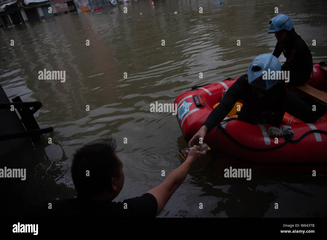 Rescuers evacuate local residents by inflatable life boat from flooded ...