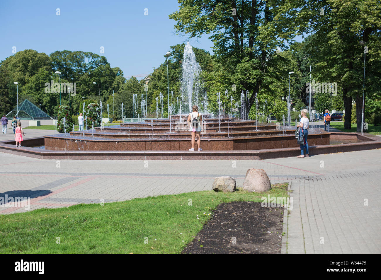 City Riga, Latvian Republic. People stand and look at the fountain.2019. 24.  July. Travel photo Stock Photo - Alamy