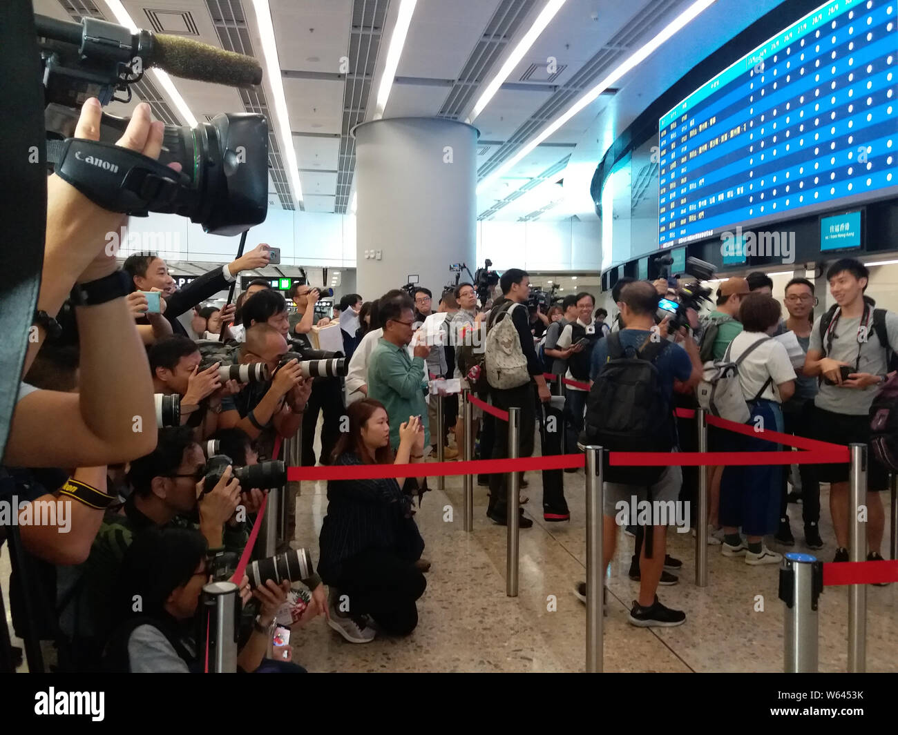Citizens stand in line to buy Tickets for trains on Guangzhou-Shenzhen-Hong Kong Express Rail Link at the West Kowloon railway station in Hong Kong, C Stock Photo