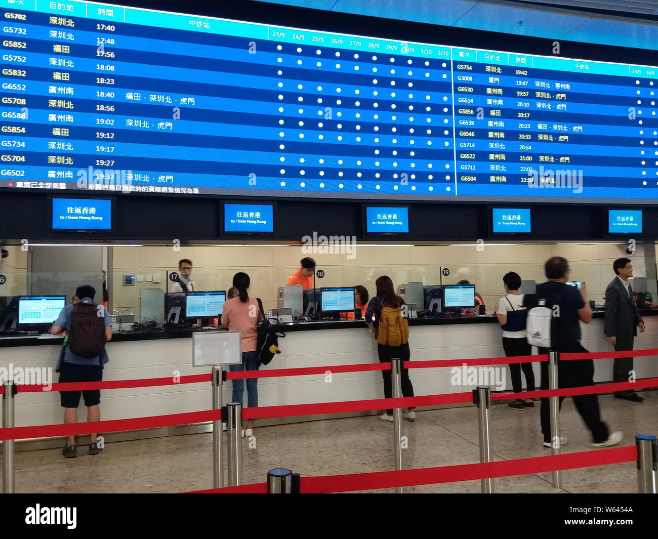 Citizens stand in line to buy Tickets for trains on Guangzhou-Shenzhen-Hong Kong Express Rail Link at the West Kowloon railway station in Hong Kong, C Stock Photo