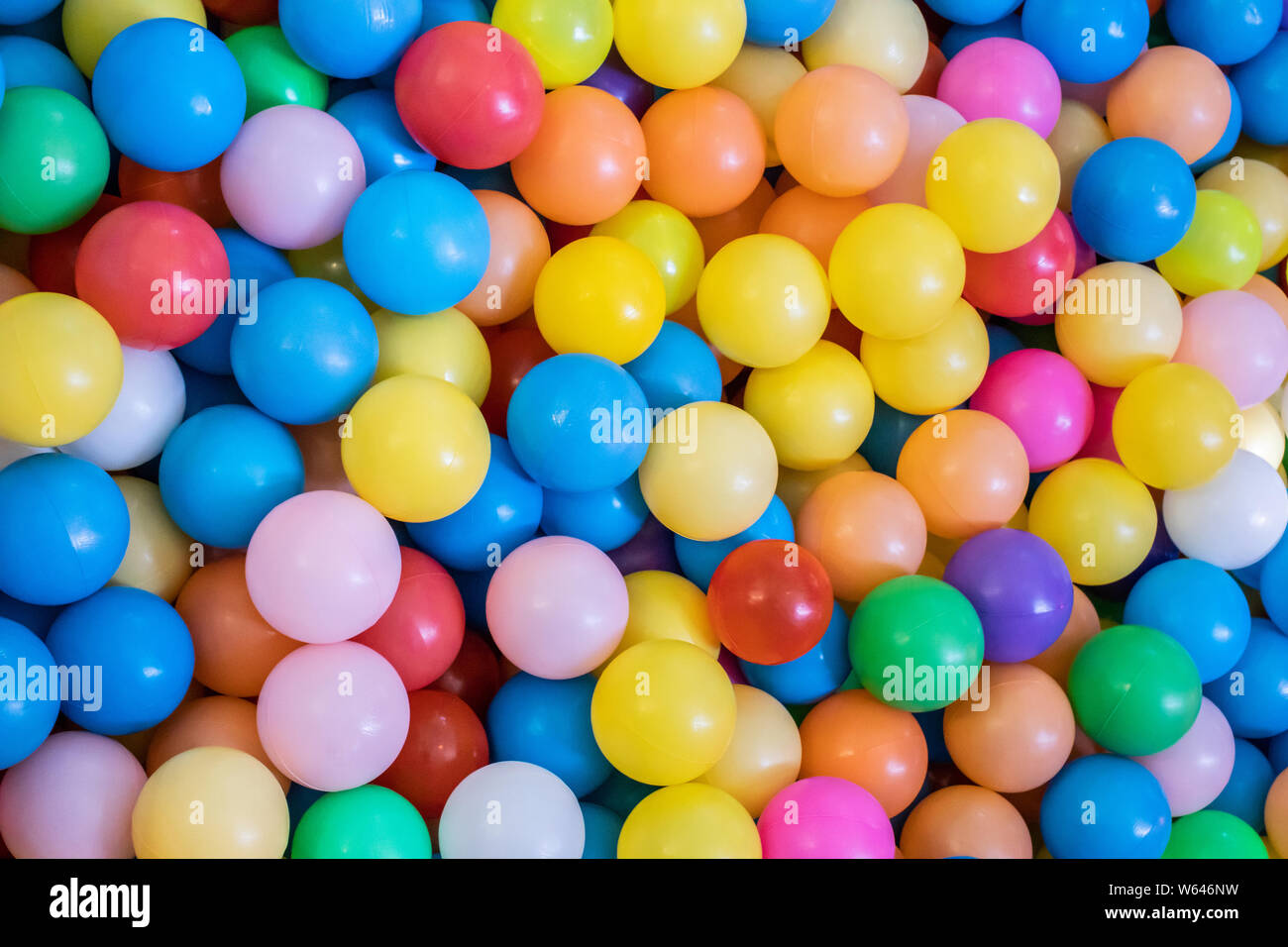 Top view many colorful plastic gum balls in kid playroom at indoors playground. Stock Photo