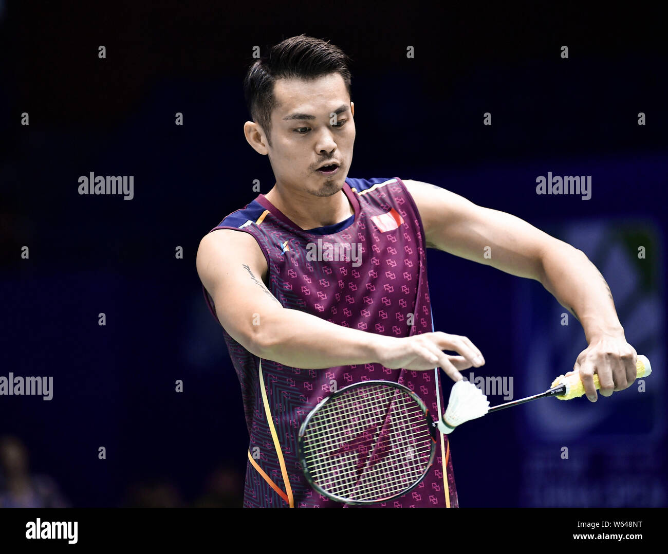 Lin Dan of China serves against Anthony Ginting of Indonesia in their first round match of the men's singles during the VICTOR China Open 2018 in Chan Stock Photo