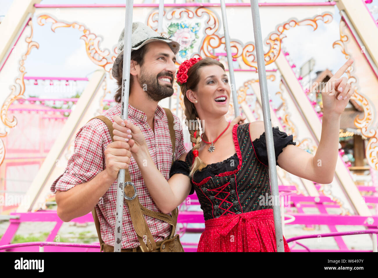 Woman and man enjoying a swing on the Oktoberfest Stock Photo