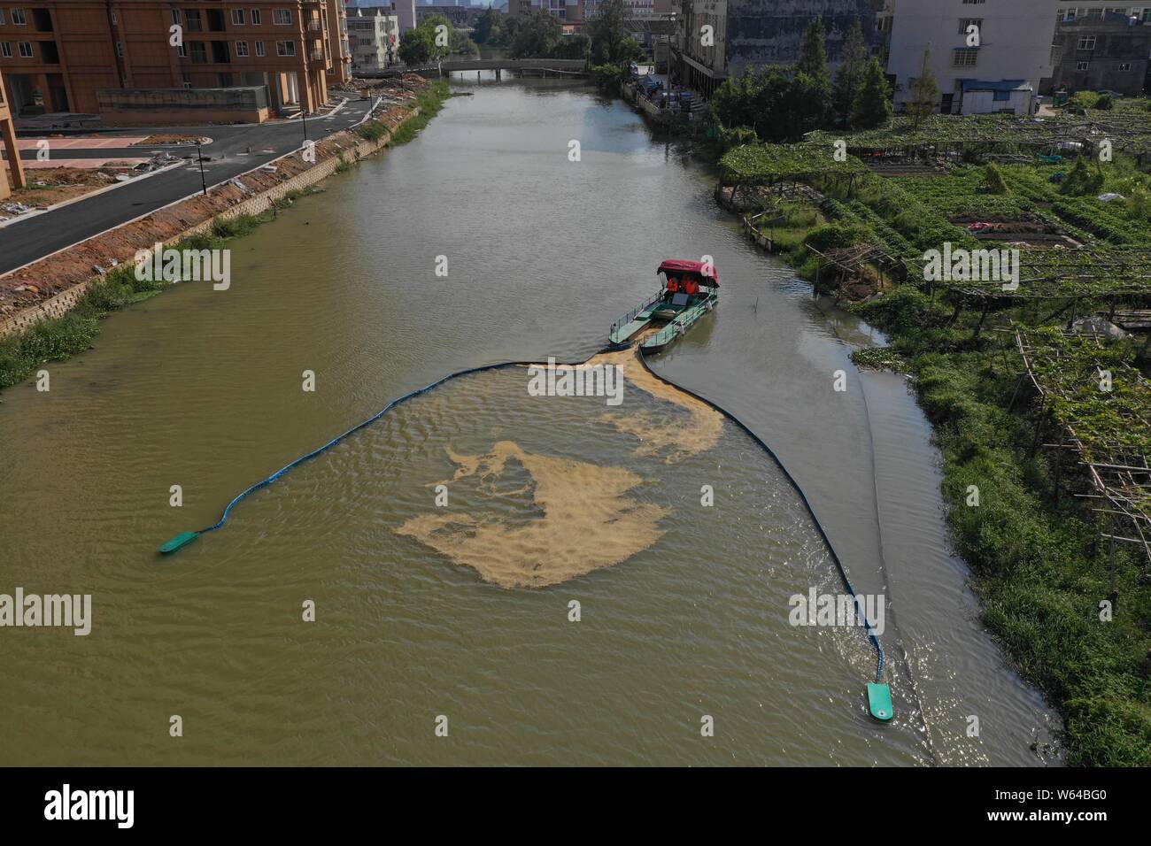 In this aerial view, a boat equipped with a new device collects garbage in a river in Xujiazhan village, Pingyang county, Wenzhou city, east China's Z Stock Photo