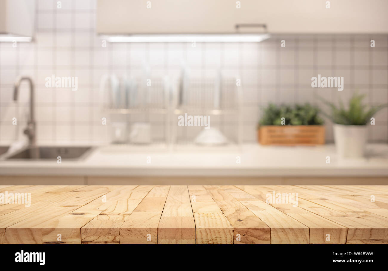 Wood table top on blur kitchen counter (room)background.For montage product display or design key visual layout. Stock Photo
