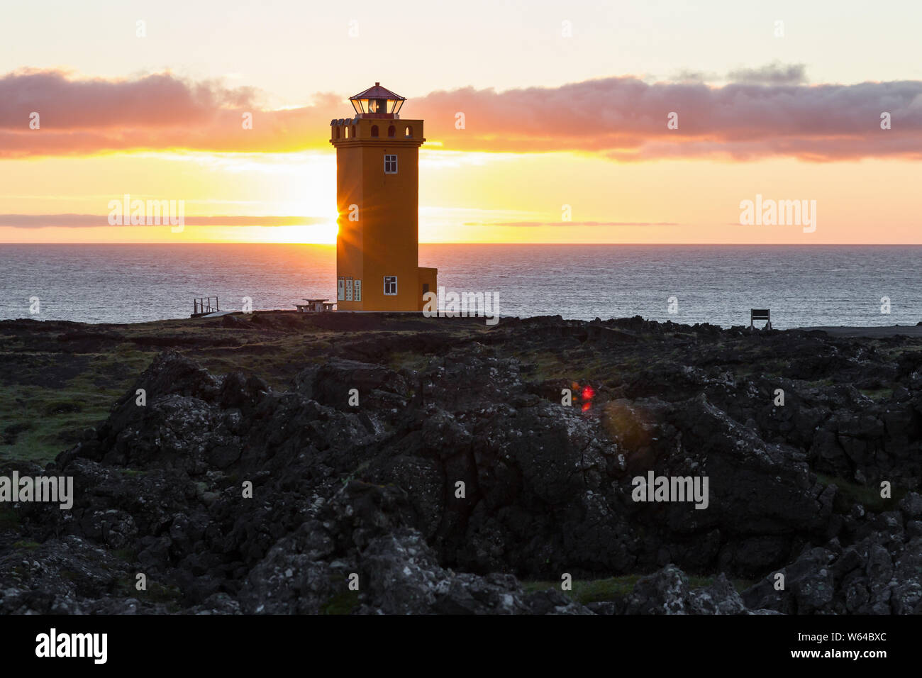 Svortuloft Lighthouse, Hellissandur in The Snaefellsjokull National Park, Snaefellsbaer, Iceland. Orange colorful sunset, good sunny weather. Stock Photo