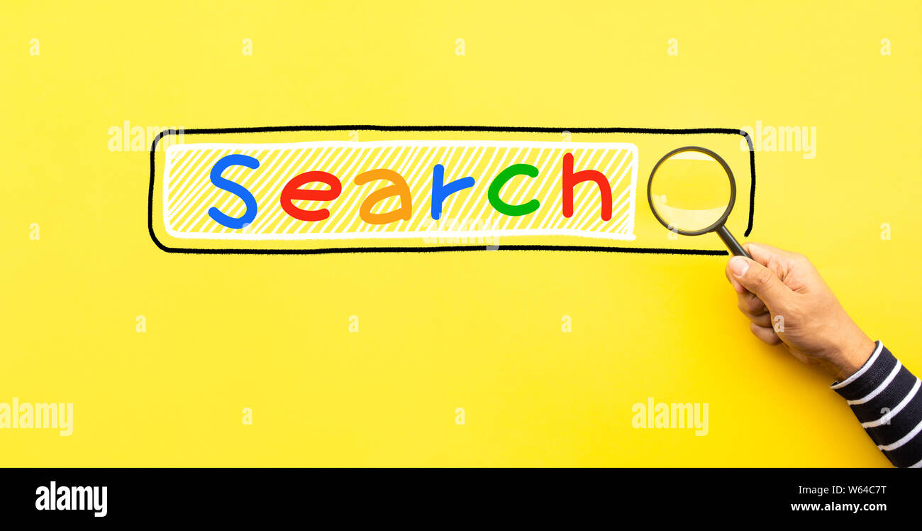 Searching concepts with male hand using magnifying glass with Search text icon on yellow space background.business performance Stock Photo