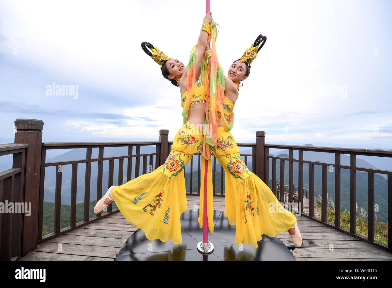 Tourists watch Chinese enthusiasts dressed in traditional costumes  featuring the shape of Chinese goddess of the Moon Chang'e performing pole  dance sk Stock Photo - Alamy