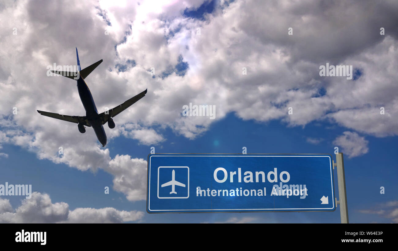 Jet plane landing in Orlando, Florida, USA. City arrival with airport direction sign. Travel, business, tourism and transport concept. Stock Photo