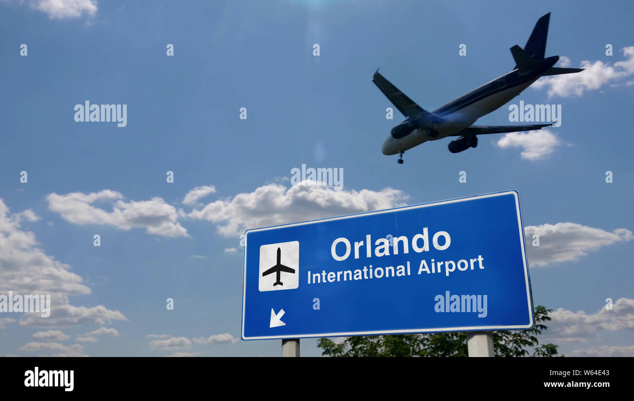 Jet plane landing in Orlando, Florida, USA. City arrival with airport direction sign. Travel, business, tourism and transport concept. Stock Photo