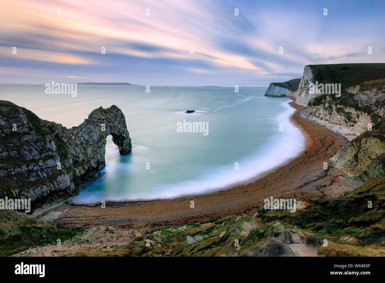 Natural limestone arch on Jurassic coastline of Dorset. Durdle Door. Looking west towards Portland Bill. High angle view. West Lulworth. North Sea. UK Stock Photo