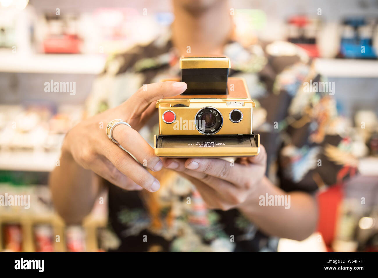 Post-90 Chinese man Yu Ji, the shop owner of Hangzhou's Polaroid camera store, shows a Polaroid camera in in Hangzhou city, east Stock Photo - Alamy