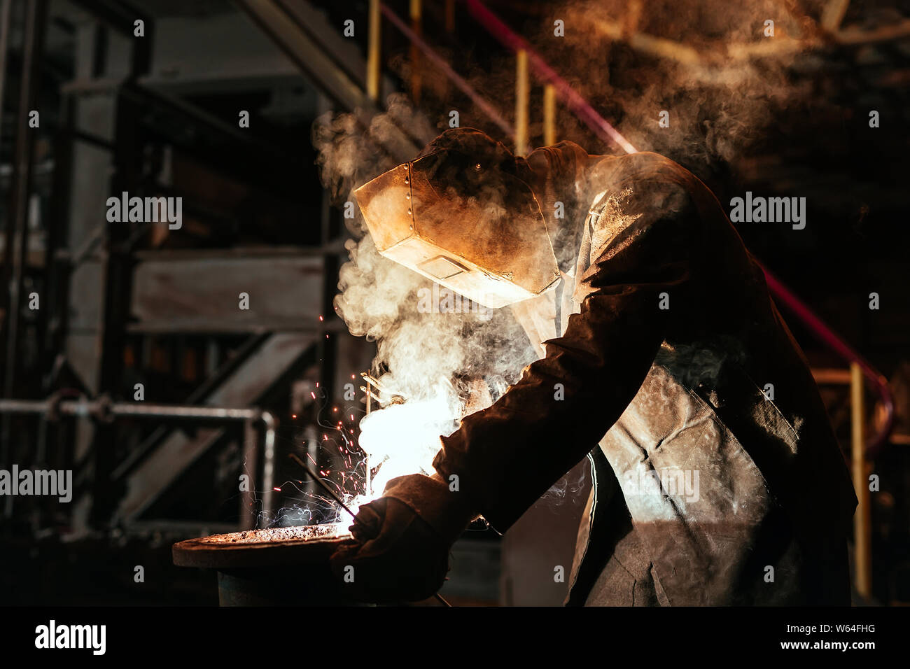 Industrial Worker at the factory welding closeup. Stock Photo