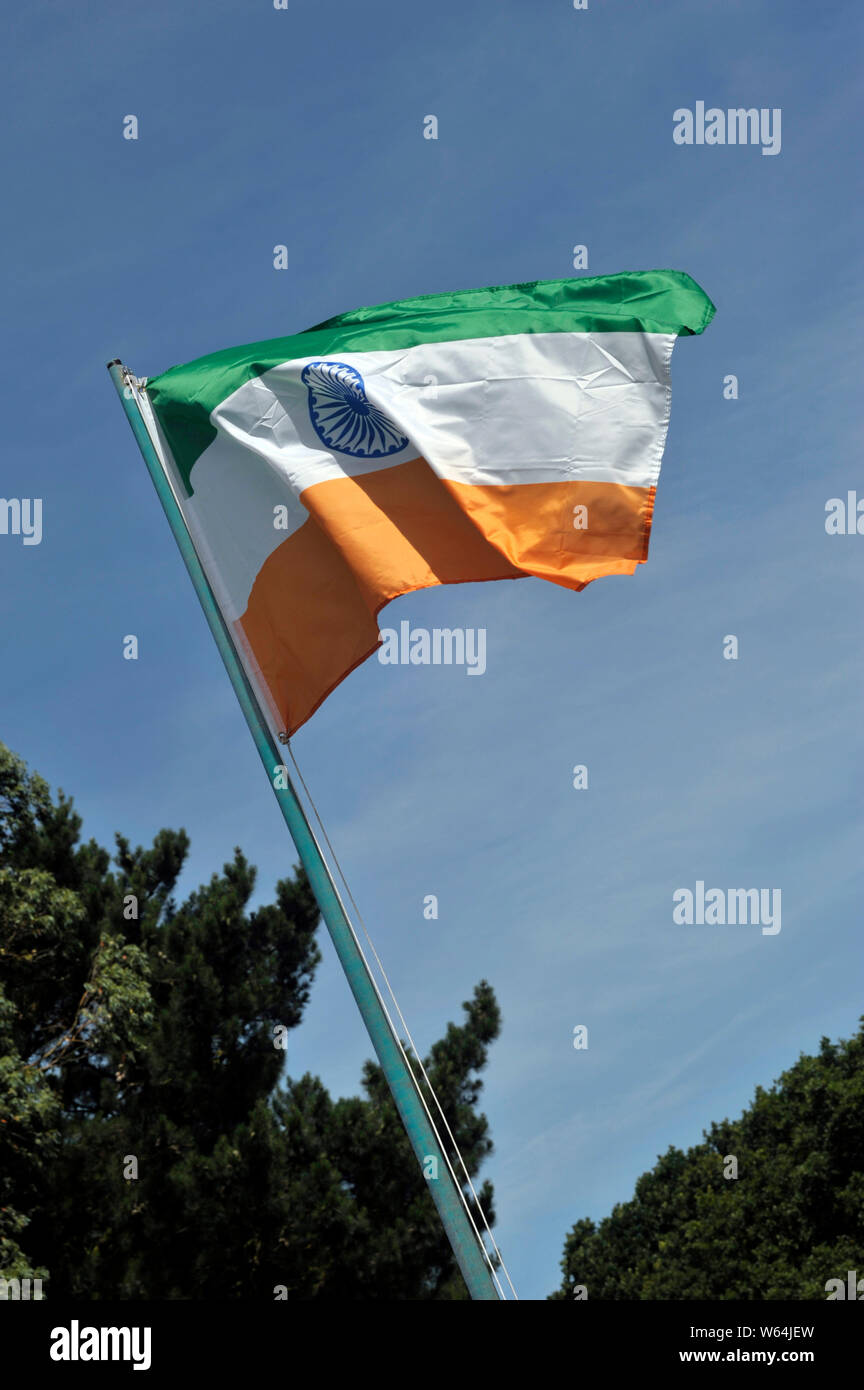 indian national flag fluttering in front of blue sky Stock Photo