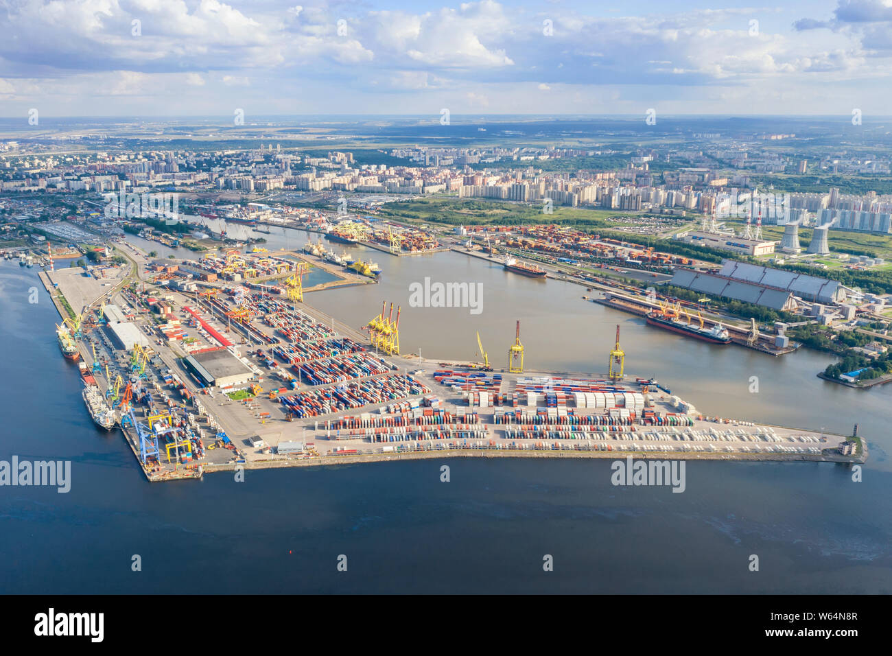 Aerial view on sea port with cargo containers in Saint Petersburg, Russia against distant city Stock Photo