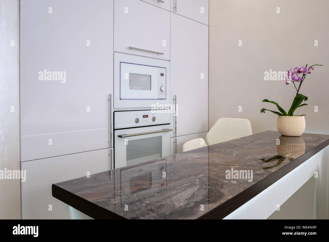 Footage of built in modules in kitchen, Interior shot. built-in microwave and oven. Interior of white modern kitchen Stock Photo