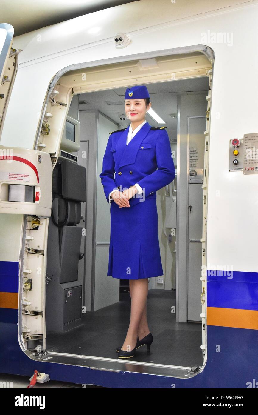 A flight attendant of China Southern Airlines presents a uniform during an open day in Guangzhou city, south China's Guangdong province, 26 September Stock Photo