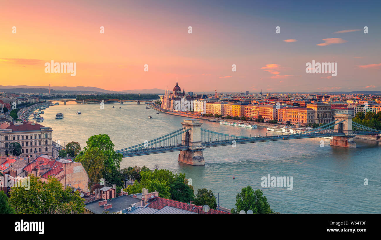 Budapest, Hungary. Panoramic aerial cityscape image of Budapest panorama with Szechenyi Chain Bridge and parliament building during summer sunset. Stock Photo