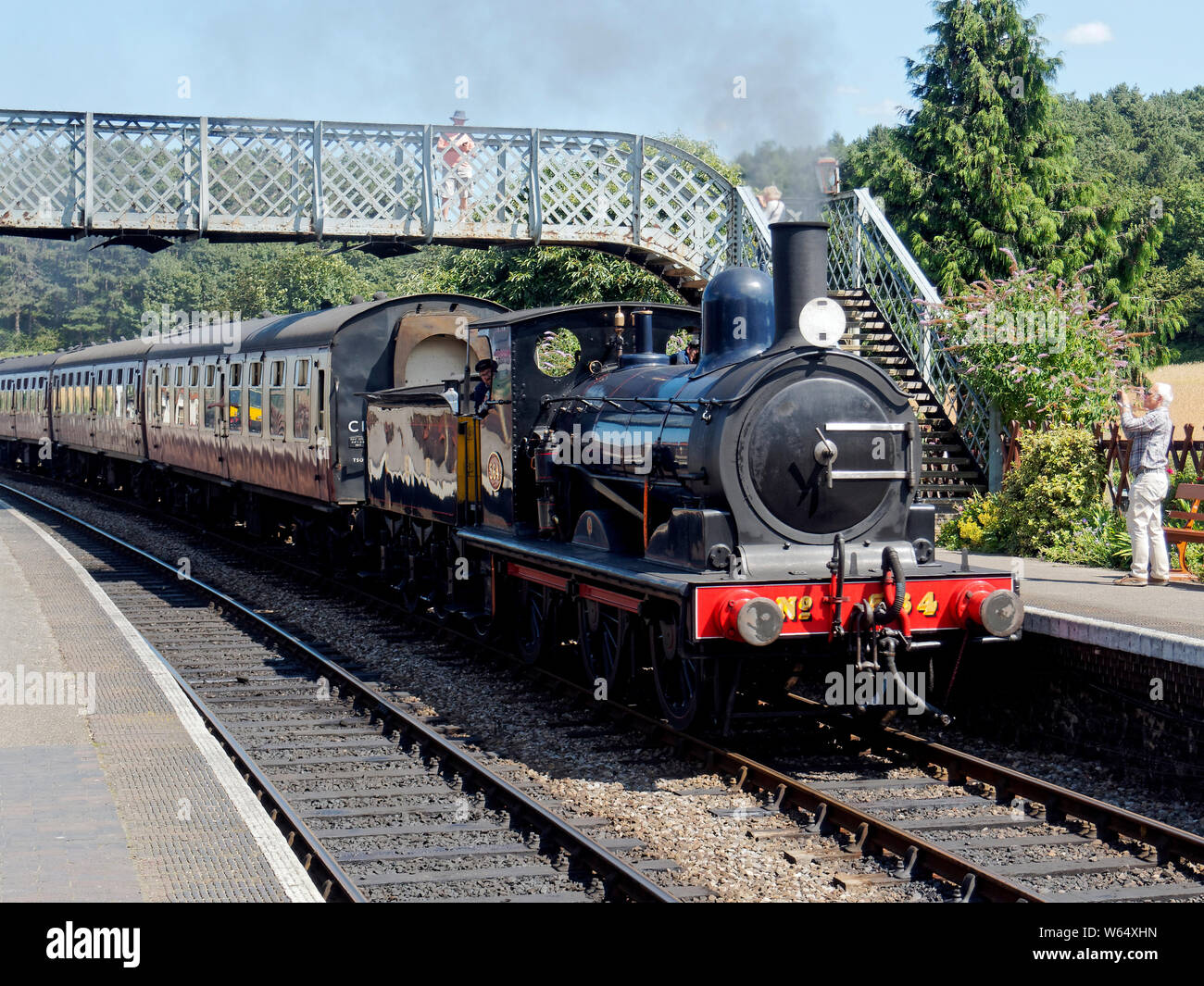 The unique Great Eastern Railway built Y14 class steam engine ruins into Weybourne Station on the North Norfolk Railway with a train for Holt. Stock Photo