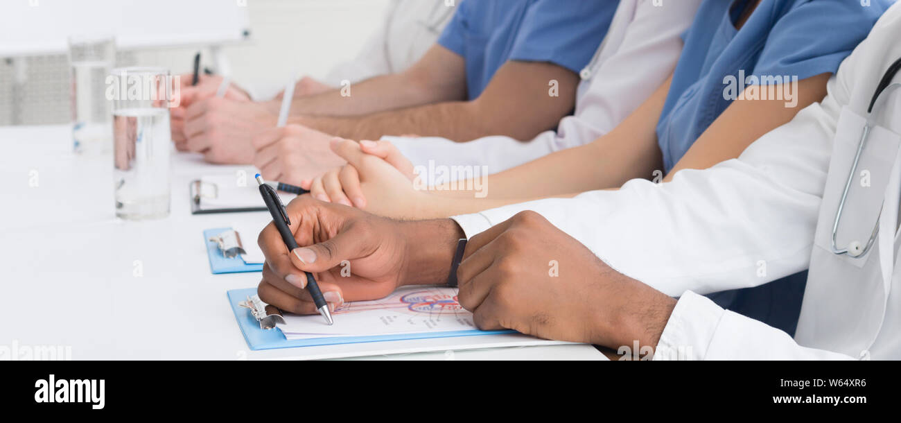 Medical education. African-american doctor writing notes closeup Stock Photo