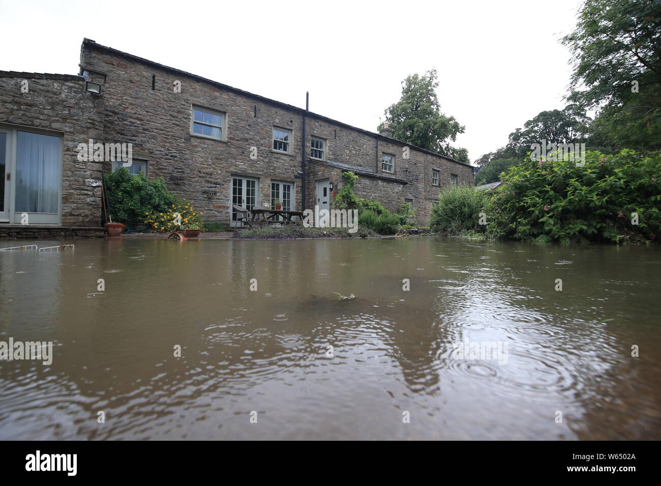 A house is surrounded by flood water in Yorkshire, after parts of the region had up to 82.2mm of rain in 24 hours on Tuesday. Stock Photo