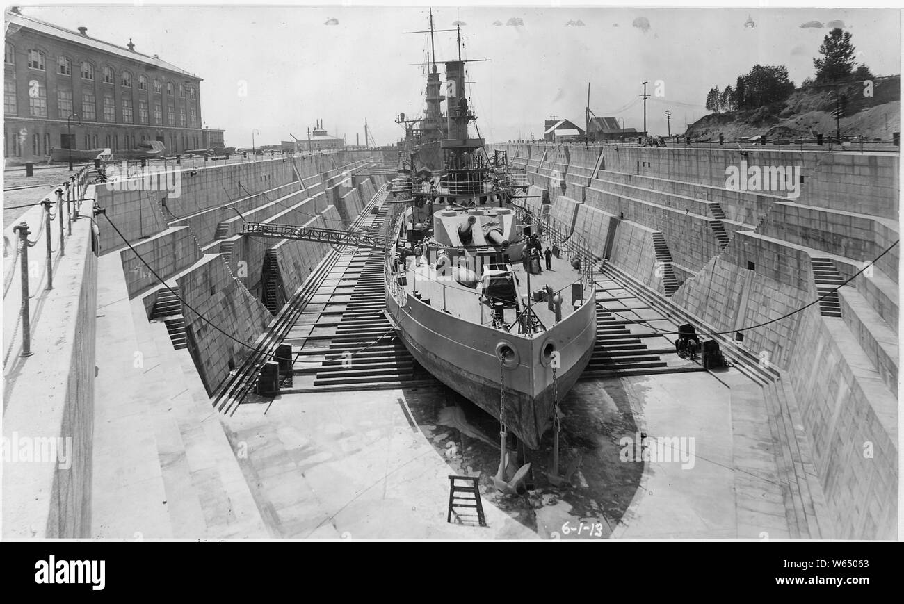 Dry Dock No. 2, looking south. USS Cheyenne (BM-10) and USS Milwaukee (C-21, in front) in dock.; General notes:  The monitor USS Cheyenne (BM-10, ex Wyoming) entered the Puget Sound Navy Yard early in February 1913, and was fitted out as a submarine tender over the ensuing months. Stock Photo