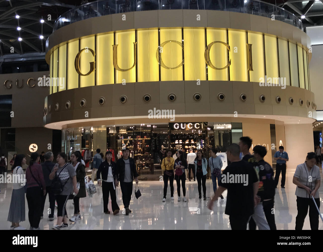 FILE--Customers walk past a boutique of Gucci in Shanghai, China, 3 October  2017. Global luxury brands from Prada to LVMH are investing in China Stock  Photo - Alamy