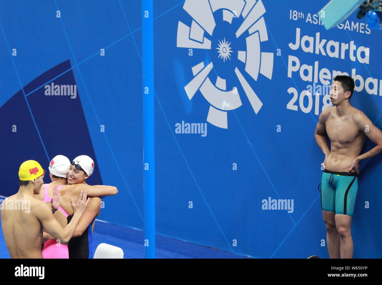 China's mixed 4x100 medley relay team celebrates after winning the