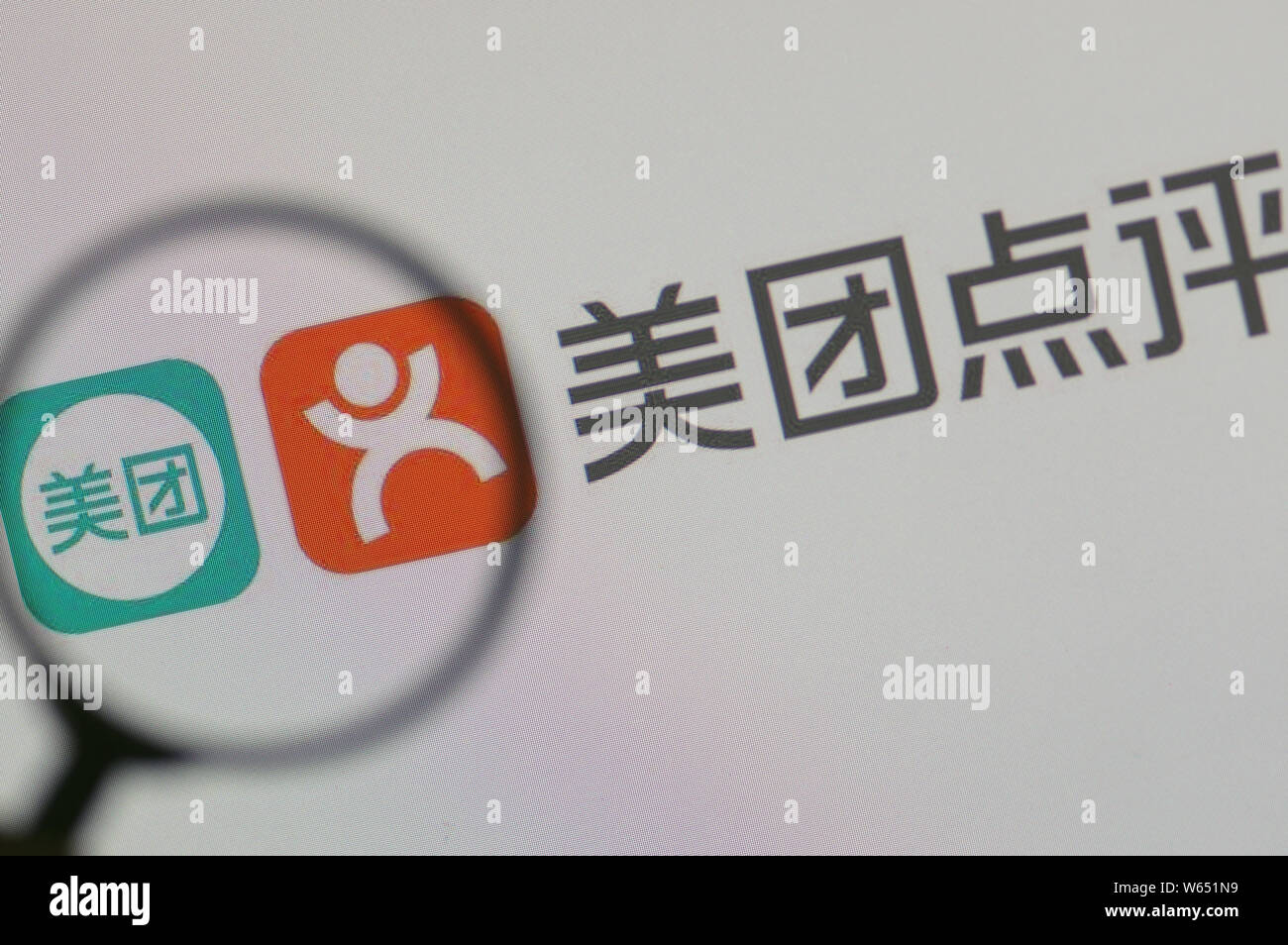 --FILE--A Chinese netizen looks at logos of online group buying site ...