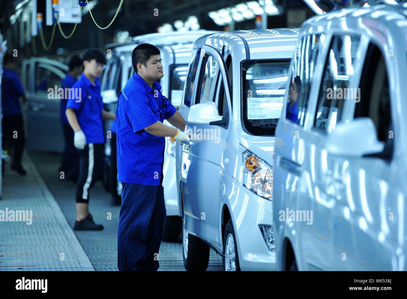 Chinese workers assemble Wuling Motors on the assembly line at an auto ...