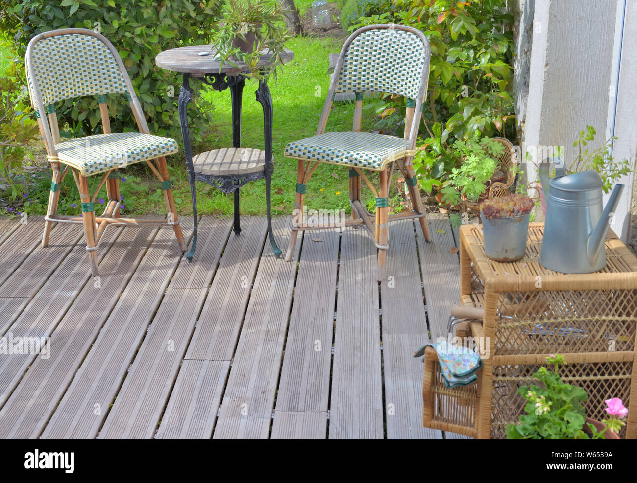 chairs and other garden furniture on a wooden terrace Stock Photo - Alamy