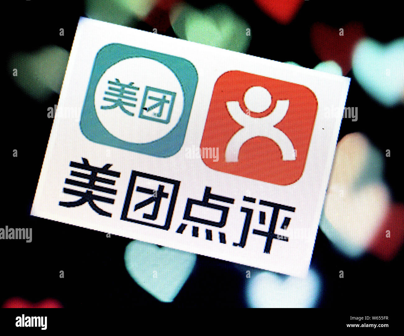 --FILE--A Chinese netizen looks the logos of online group buying site ...