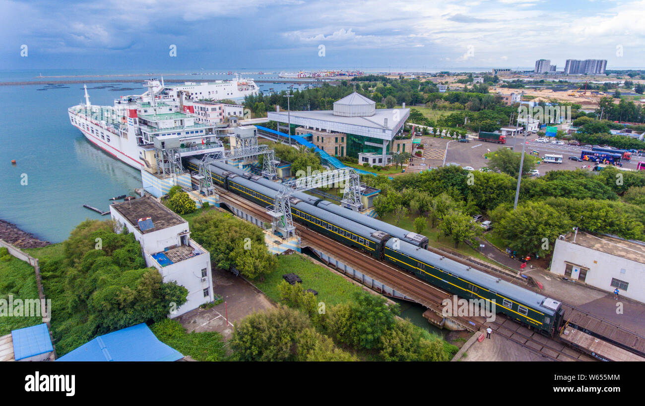 FILE--Passenger trains runs to disembark from a ferry at the Nangang Port  in Haikou city, south China's Hainan province, 26 July 2018. Yuehai Rail  Stock Photo - Alamy