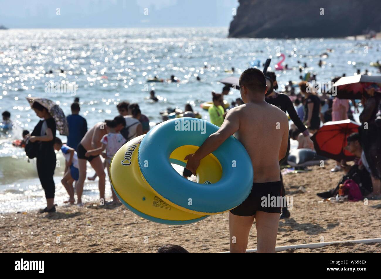 Holidaymakers crowd a beach resort to cool off on a scorching day after 'Liqiu,' meaning the start of autumn, one of the traditional 24 solar terms, i Stock Photo
