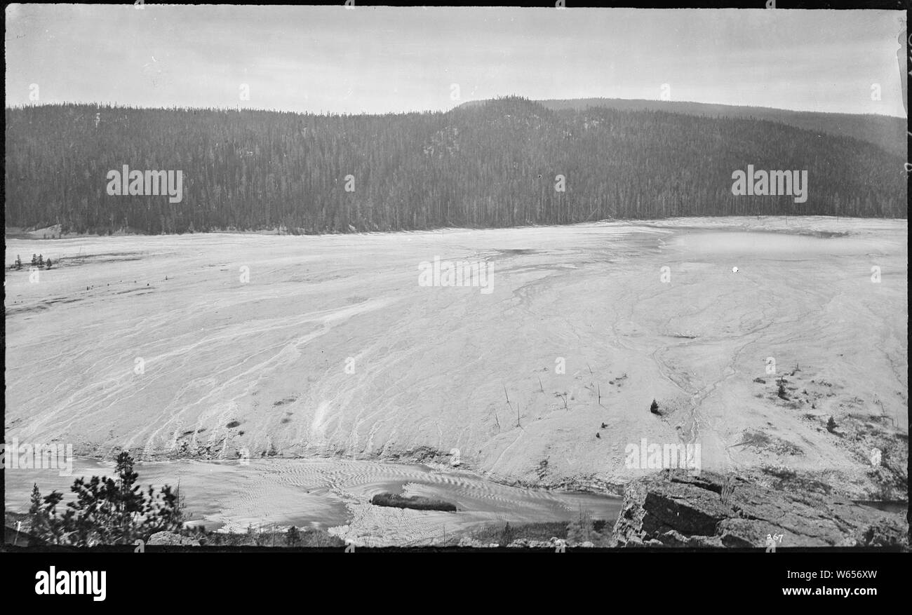 Excelsior or Midway Geyser basin. Yellowstone; Excelsior Geyser is not actually visible in this image; it's just to the right of the frame.  Grand Prismatic Spring is visible on the right. Stock Photo