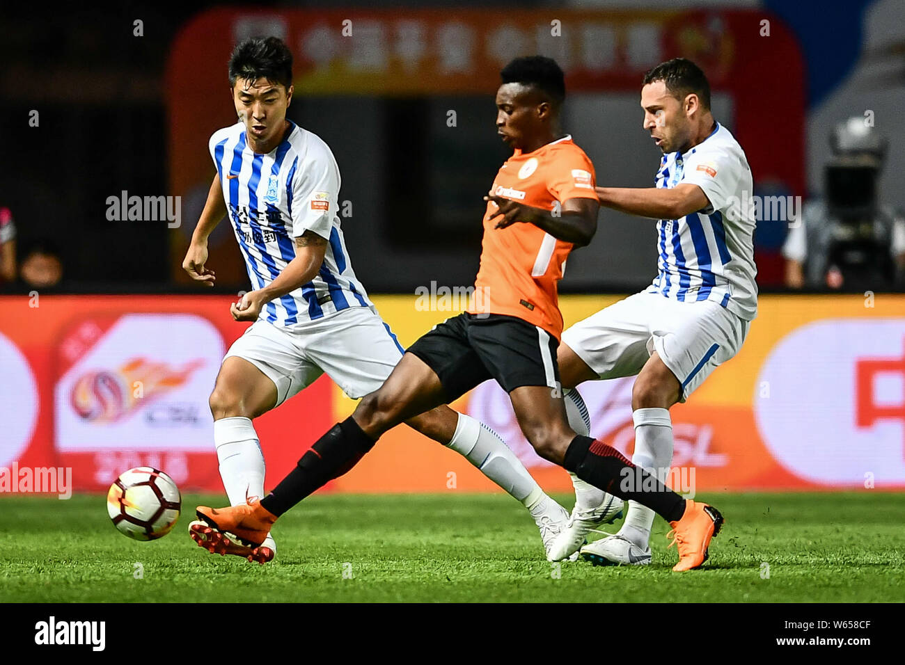 Serbian football player Dusko Tosic, right, of Guangzhou R&F challenges Cameroonian football player Benjamin Moukandjo of Beijing Renhe in their 15th Stock Photo