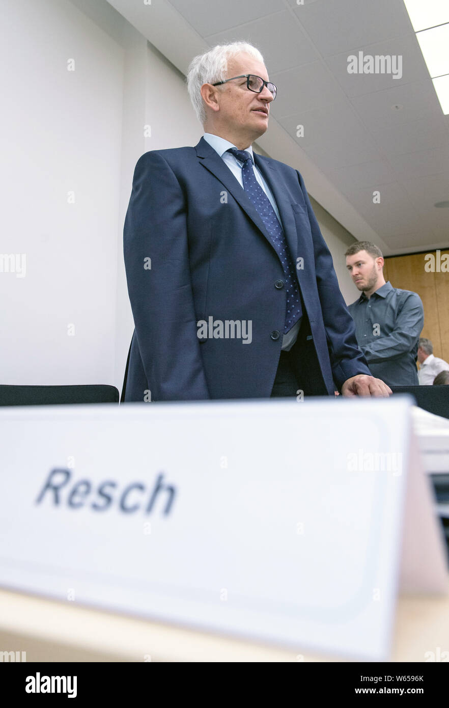 31 July 2019, North Rhine-Westphalia, Münster: Jürgen Resch, Federal Managing Director of Deutsche Umwelthilfe, is about to stand trial in the courtroom. The Higher Administrative Court of North Rhine-Westphalia is hearing the action brought by Deutsche Umwelthilfe (German Environmental Aid) against the city of Aachen for the continuation of the Cologne district government's air pollution control plans. The aim is to take measures to ensure that the limit values for nitrogen dioxide are complied with as quickly as possible. Photo: Guido Kirchner/dpa Stock Photo