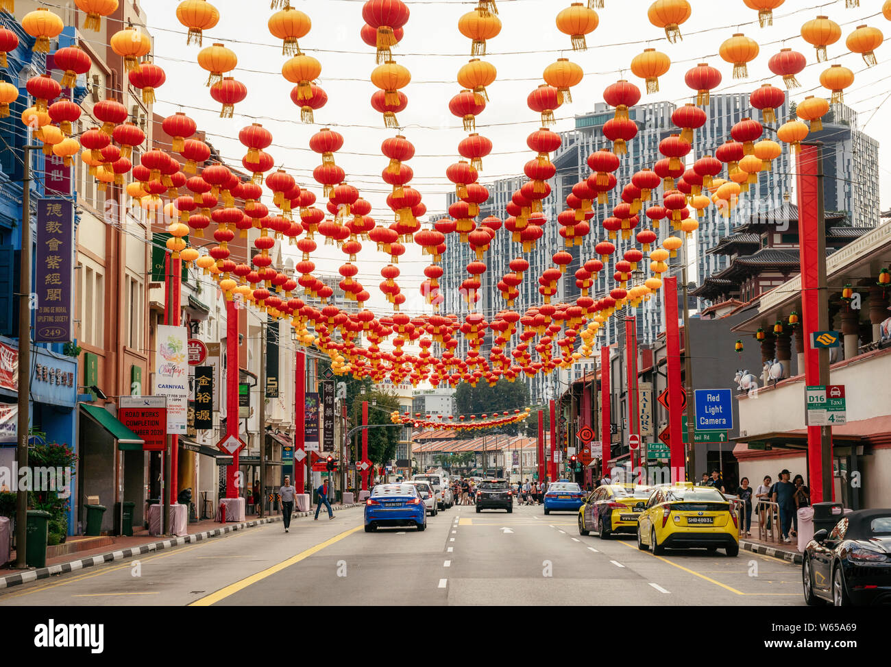 Chinatown, Singapore - February 8, 2019: cars and people on South Bridge Road near Sri Mariamman Temple in Chinatown district with colorful lanterns f Stock Photo