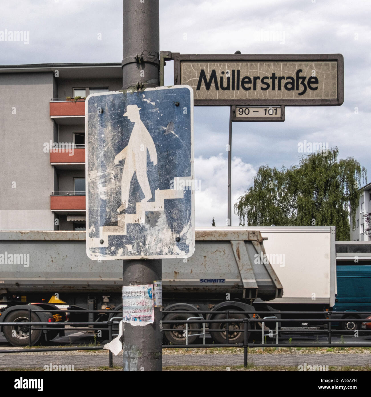 Müllerstraße street sign In Wedding-Berlin.Weathered picture of man walking down stairs Stock Photo