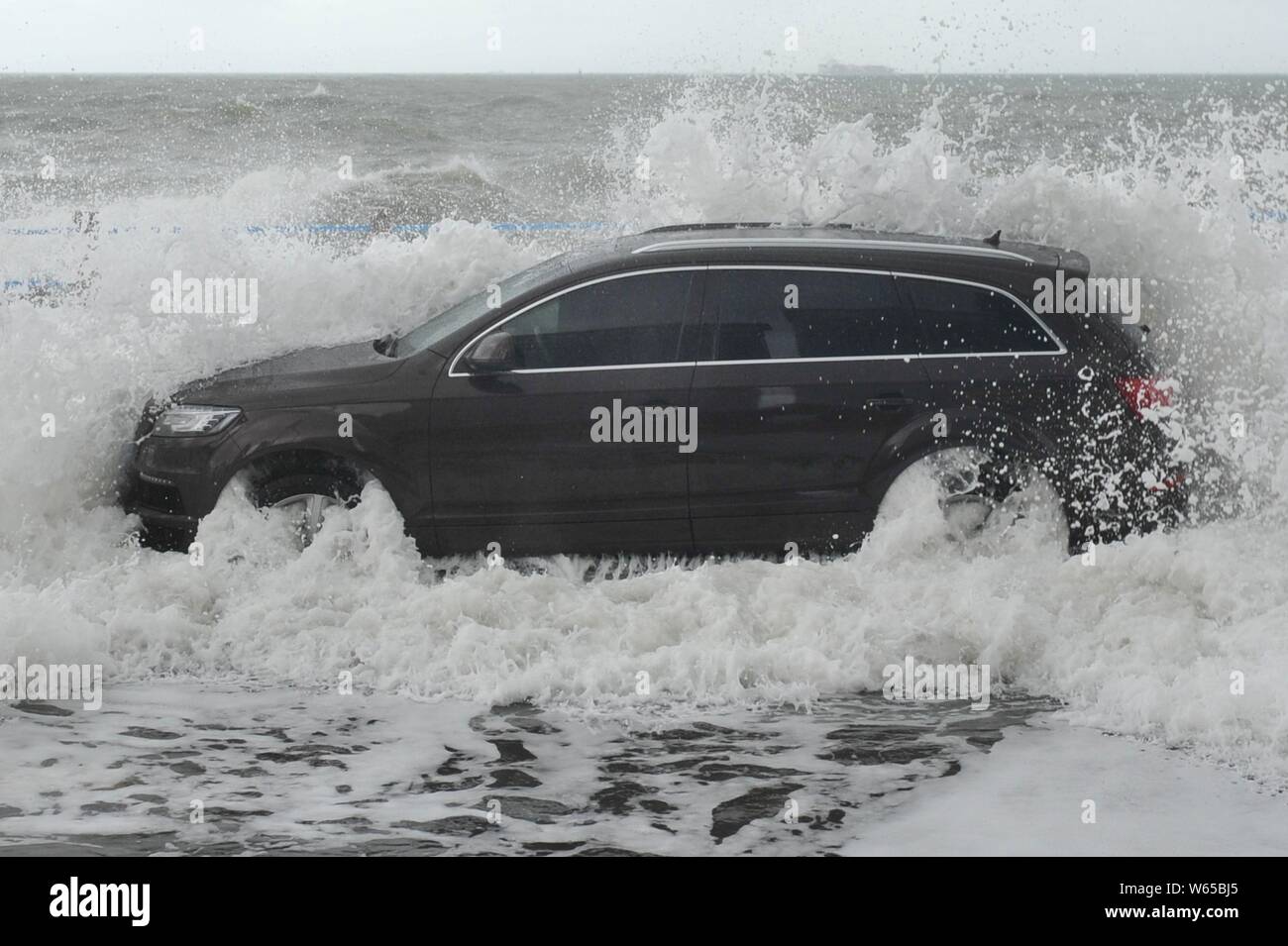 A car is hit by strong wind and wave caused by Typhoon Yagi, the 14th