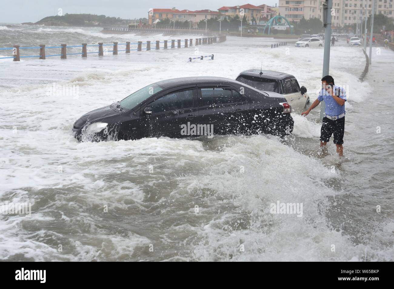 Cars are hit by strong wind and wave caused by Typhoon Yagi, the 14th