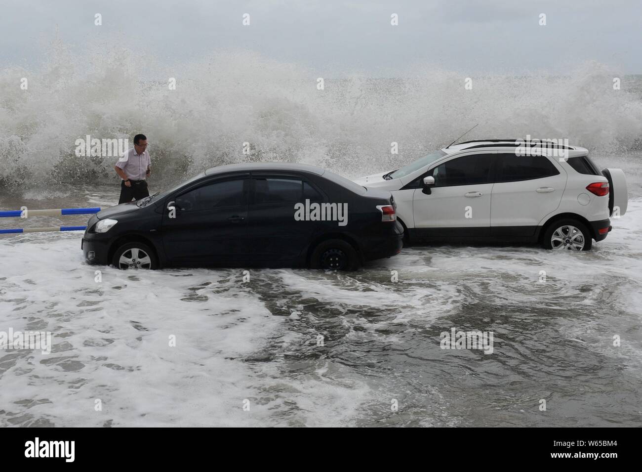 Cars are hit by strong wind and wave caused by Typhoon Yagi, the 14th