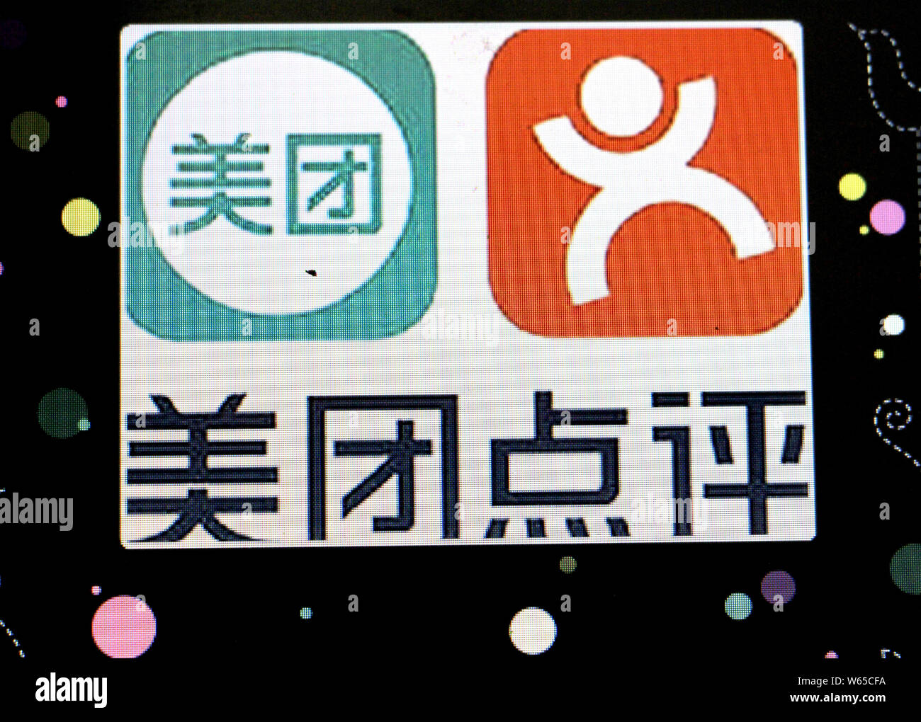 --FILE--A Chinese netizen looks the logos of online group buying site ...