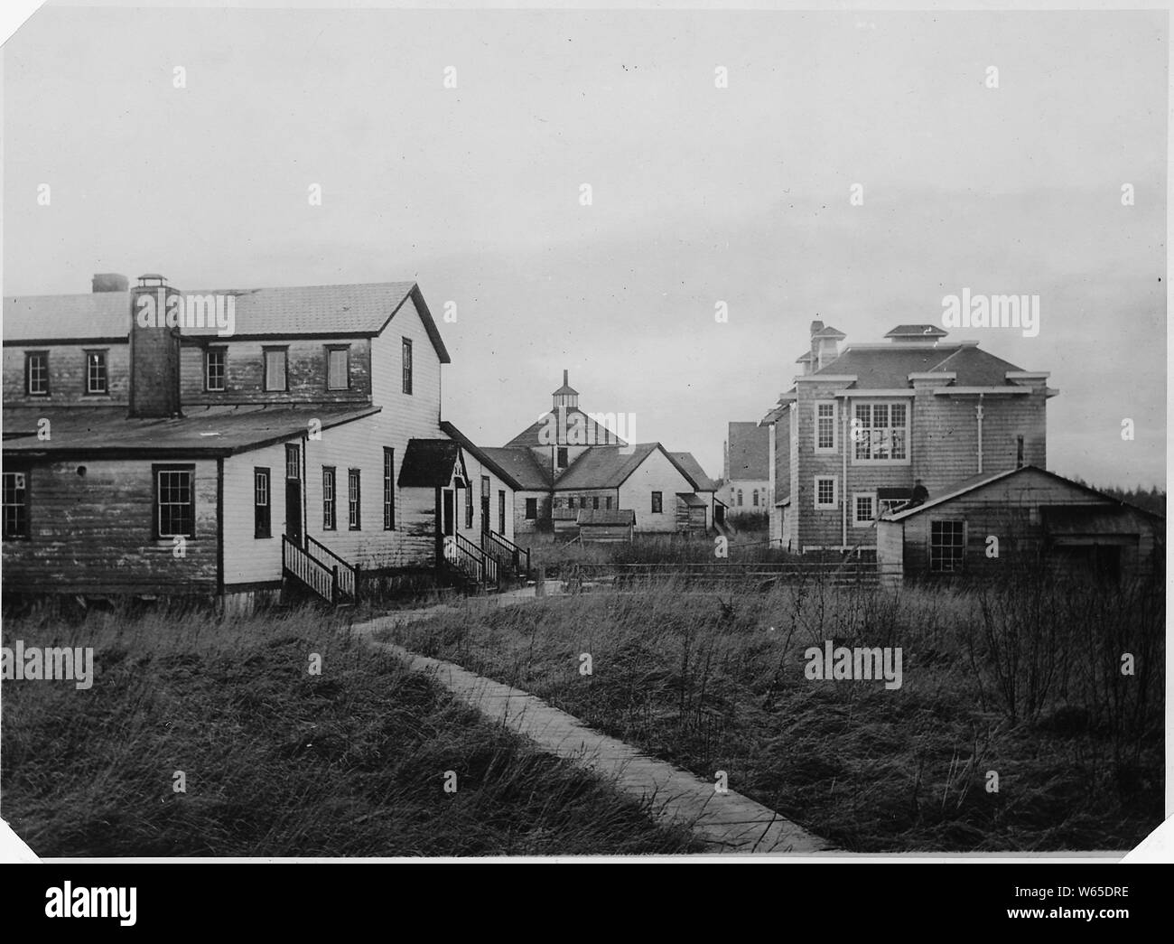 Front view of Mission Building, on left; Mission School, in center. On ...