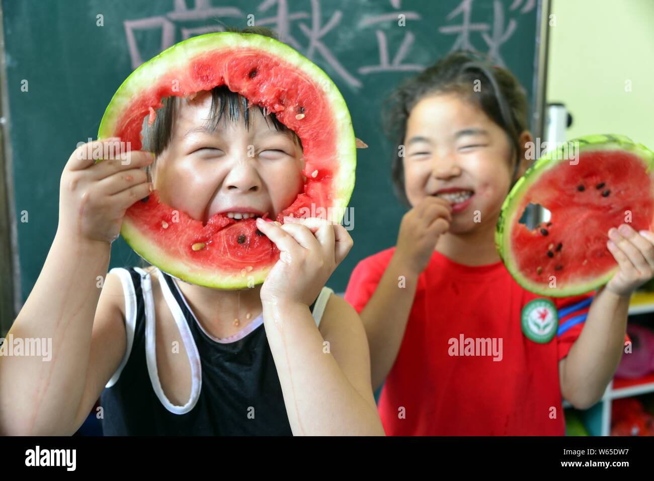 Children from Jinling Kindergarten eat watermelons to mark Liqiu, meaning the start of autumn, one of the traditional 24 solar terms, in Liaocheng cit Stock Photo