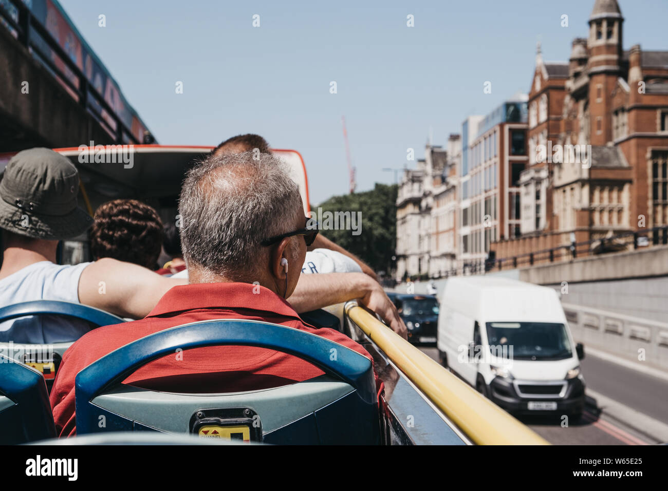 People sitting on the top of bus roof hi-res stock photography and ...