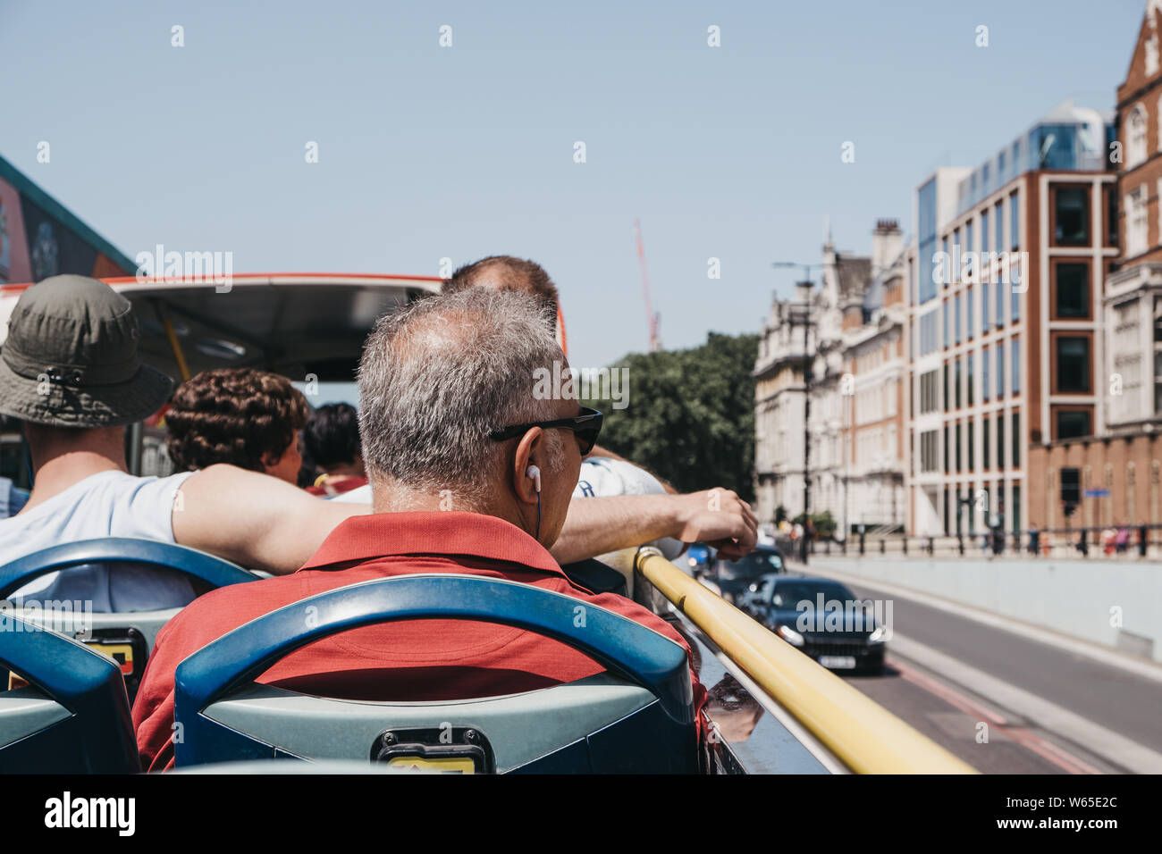 People sitting on the top of bus roof hi-res stock photography and ...